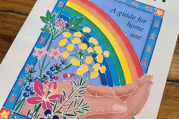 Book with hand rainbow and aromatherapy essential oils