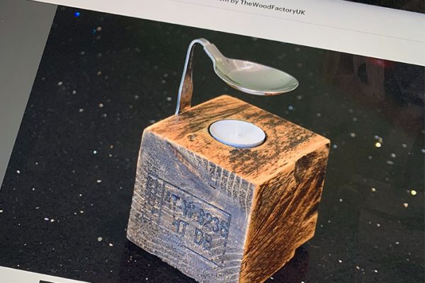 Website on an iPad, wooden oil burner with silver spoon