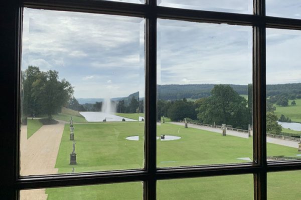 Chatsworth House looking through a window into the garden and water fountain